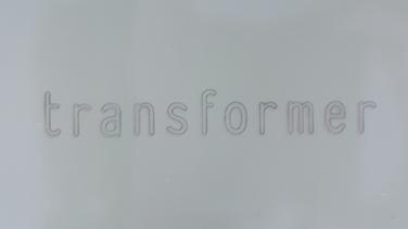 The Transformer logo on a light grey background