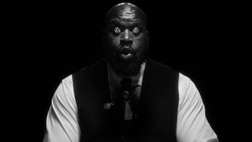 Shaquille O'Neal wearing a suit with spirals in his eyes