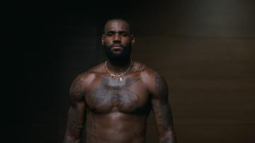 A shirtless tattooed black man with a well-defined, muscular torso.
