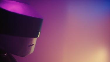 Half of a space helmet against a purple and fuchsia and yellow gradient background.