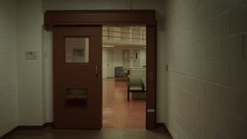 The interior of a prison seen through a doorway.